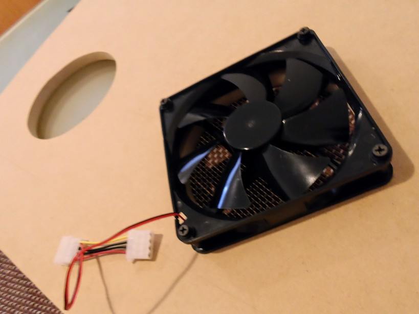 A PC fan attached to one of the big holes