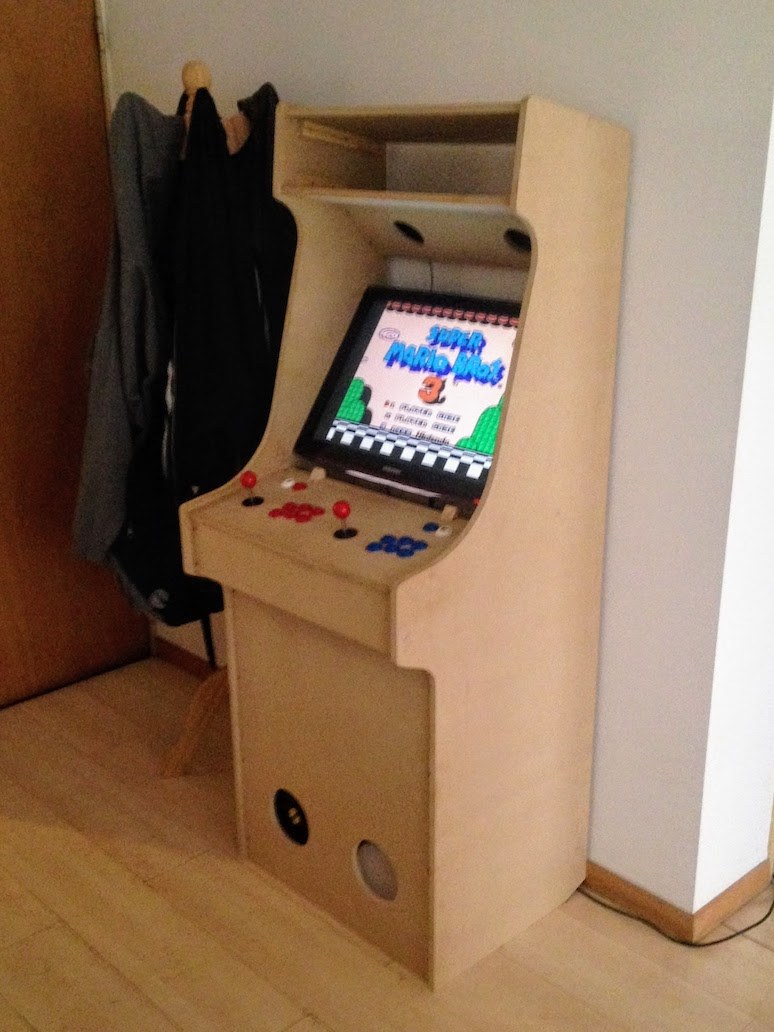 The arcade cabinet, with everything installed. A game can be seen on the monitor.