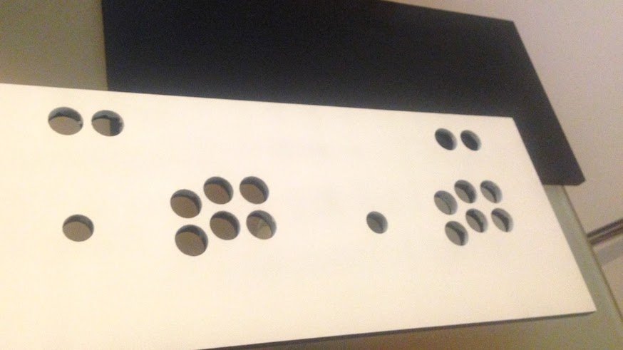 The wooden board with 18 holes painted in glossy white