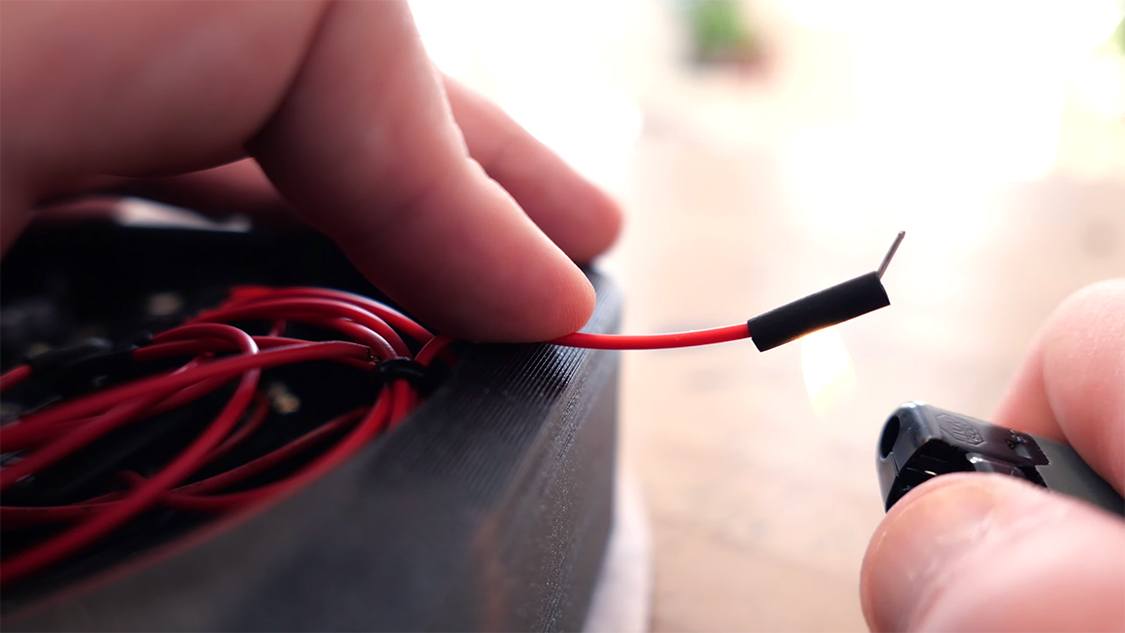 A red wire with a Dupont end and a heat-shrink tubing