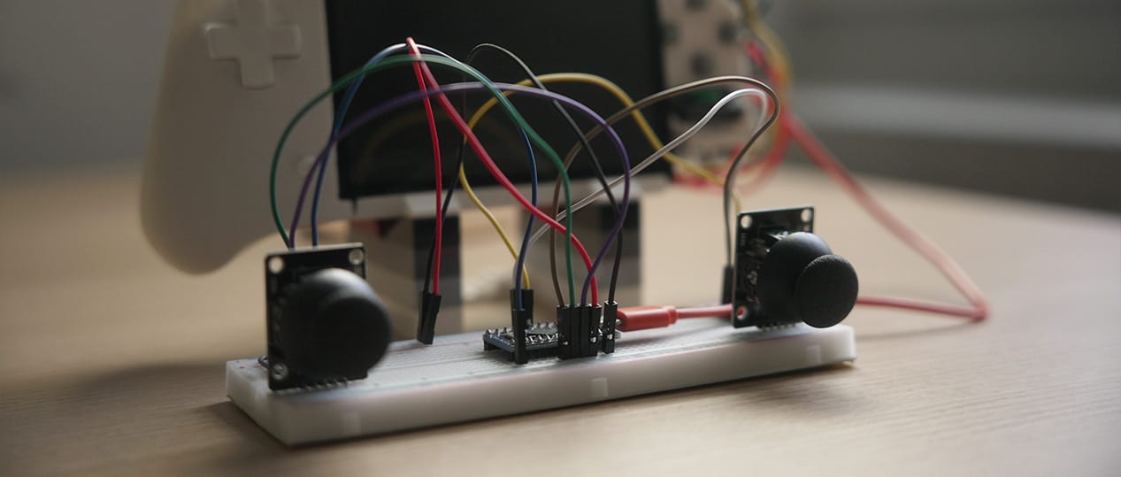 Analog sticks connected to an Arduino Pro Micro, connected to the handheld game console.